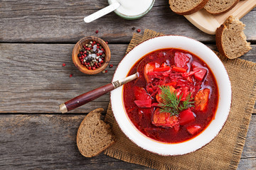 Traditional Ukrainian Russian borscht on wooden table. top view