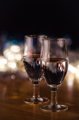  New Year. Glasses with champagne. New Year on the table are glasses of champagne and in the background is a beautiful bokeh. New year happy mood.