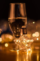  New Year. Glasses with champagne. New Year on the table are glasses of champagne and in the background is a beautiful bokeh. New year happy mood.