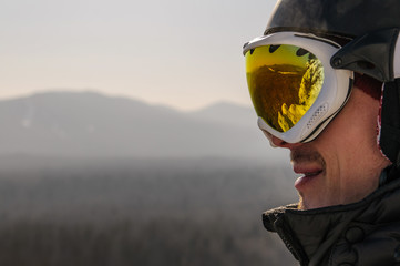 snowboarder in helmet and mask on top