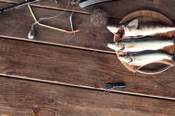 The catch of fresh sea fish lies on a cutting Board on a wooden table in the kitchen Selective focus copy space
