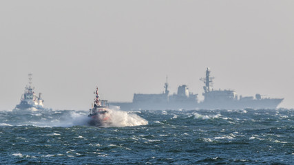 STORMY SEA - Outline of a warship on the horizon and Pilots Vessel © Wojciech Wrzesień