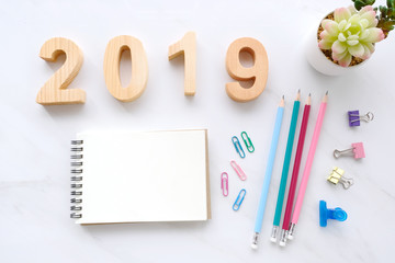 2019 wood letters, blank notebook paper and ornament on white wood background, 2019 new year mock up, template with copy space for text, top view