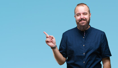 Young caucasian hipster man over isolated background with a big smile on face, pointing with hand and finger to the side looking at the camera.