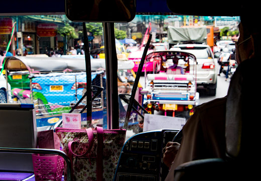 Traffic jam on the streets of Bangkok, view of public bus. Bus ride in the metropolis.