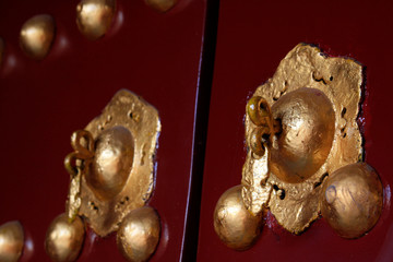 copper door knocker on the red door plank, China