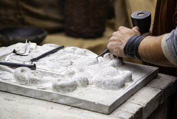 Carving stone in a traditional way - obrazy, fototapety, plakaty