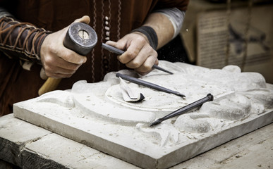 Carving stone in a traditional way - obrazy, fototapety, plakaty