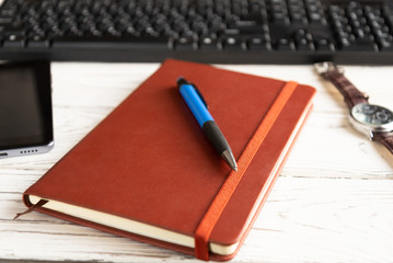 brown red notebook on a light background.