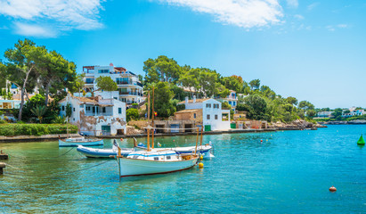 Fototapeta na wymiar Landscape with boat and Cala D'or village, Palma Mallorca Island, Spain