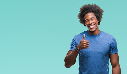 Afro american man over isolated background doing happy thumbs up gesture with hand. Approving expression looking at the camera with showing success.