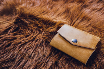 leather craftsman working making products at table in workshop studio.