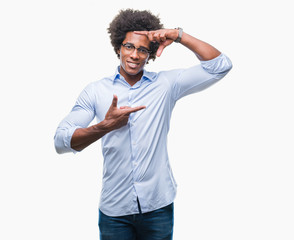 Fototapeta premium Afro american business man wearing glasses over isolated background smiling making frame with hands and fingers with happy face. Creativity and photography concept.