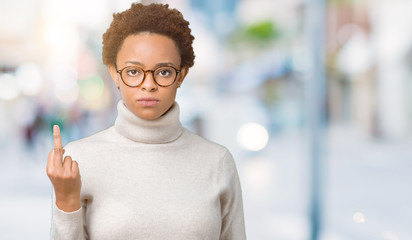 Young beautiful african american woman wearing glasses over isolated background Showing middle finger, impolite and rude fuck off expression