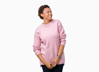 Beautiful young african american woman over isolated background looking away to side with smile on face, natural expression. Laughing confident.
