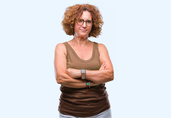 Middle age hispanic woman wearing glasses over isolated background skeptic and nervous,...