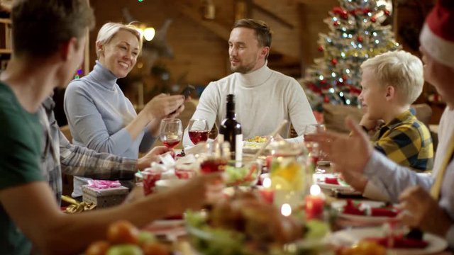 Woman takes group selfie with her family on Christmas dinner