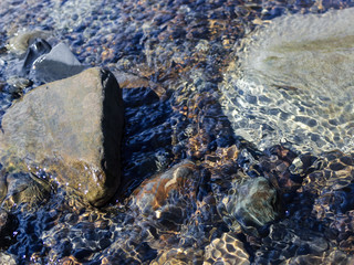 Stones and gravel at the bottom of a mountain river