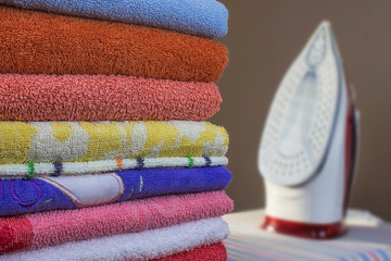 Iron and towels close up. Ironing of clean linen