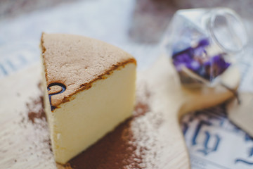 Close-up Jiggly Fluffy Japanese Cheesecake on wood Chopping board.