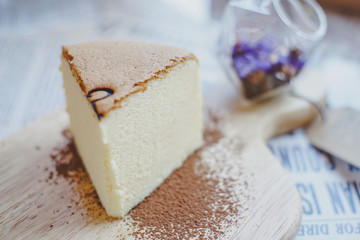 Homemade  Fluffy Japanese Cheesecake on wood Chopping board.