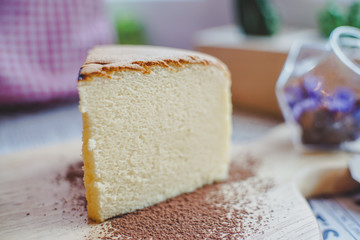 Close-up Jiggly Fluffy Japanese Cheesecake on wood Chopping board.
