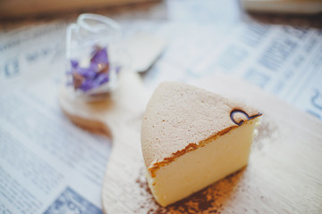 Top view of Fluffy Japanese Cheesecake on wood Chopping board and lavender.
