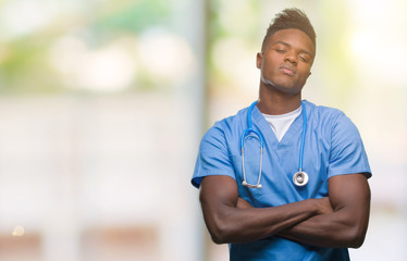 Young african american doctor man over isolated background wearing surgeon uniform skeptic and nervous, disapproving expression on face with crossed arms. Negative person.