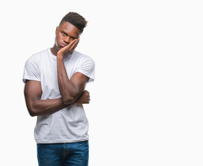 Young african american man over isolated background thinking looking tired and bored with depression problems with crossed arms.