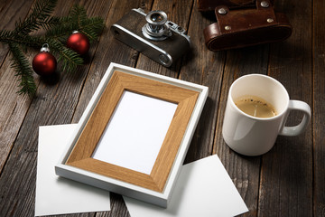 Photos, camera, pine tree branch and cup of coffee.