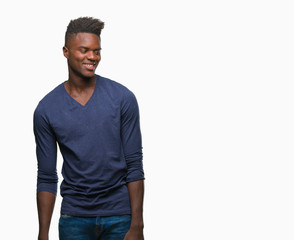 Fototapeta premium Young african american man over isolated background looking away to side with smile on face, natural expression. Laughing confident.