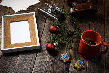 Photos, camera, pine tree branch and cup of coffee.