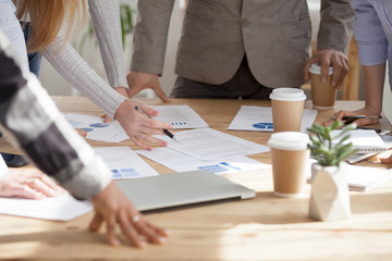 Close up of employees brainstorm at office meeting discussing paperwork documents, financial paper...
