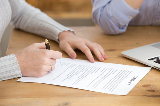 Close up of female job candidate sign contract after successful interview, woman put signature on document, finalize recruiting process, work applicant fill in paper business deal. Employment concept