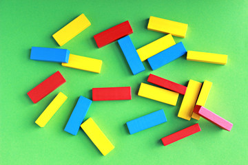 multi colored toy blocks lying on a green background