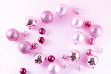 Christmas decoration balls frame on pink background