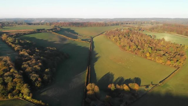 Aerial shot of rolling green hills and farmland in the beautiful Chiltern Hills, United Kingdom