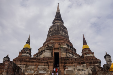 Fototapeta premium Old Ancient Temple. The statue old Buddha and ancient pagoda at Wat Yai Chaimongkol,Ayutthaya,Thailand.