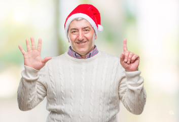 Handsome senior man wearing christmas hat over isolated background showing and pointing up with...