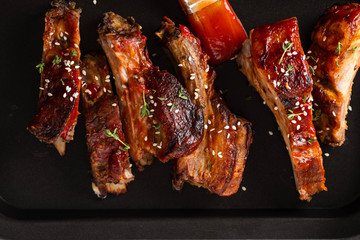 Delicious barbecued ribs seasoned with a spicy basting sauce. lose-up, copy space.