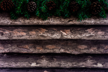 Christmas background with fir tree and pine cones on wooden table. Top view with copy space