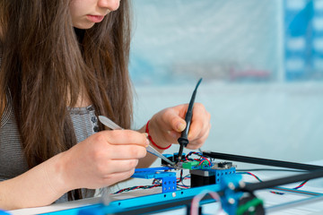 Schoolgirl in the classroom design and development of robots