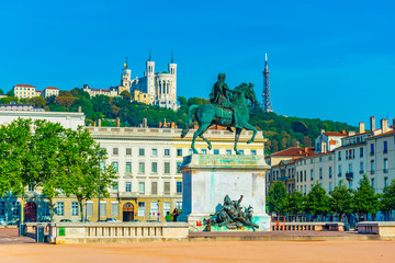 Basilica Notre-Dame de Fourviere viewed behind statue of Louis XIV in Lyon, France