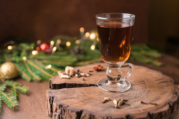 Glass of mulled wine over on wooden table. Christmas concept.
