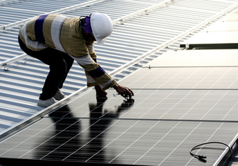 solar panel installation on roof © Eaknarin