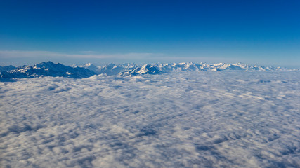 Fototapeta na wymiar flight plane window view alps landscape