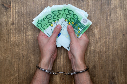 Hands In Handcuffs With  Money