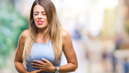 Young beautiful elegant business woman over isolated background with hand on stomach because indigestion, painful illness feeling unwell. Ache concept.