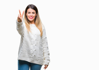 Young beautiful woman casual white sweater over isolated background showing and pointing up with fingers number two while smiling confident and happy.