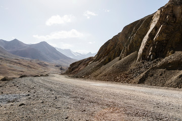 Desert landscape in the area of Ak-Baital Pass with road in the Pamir Mountains in Tajikistan